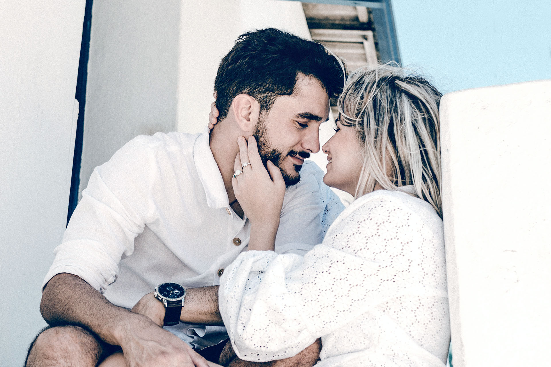 portrait of happy young woman using mobile phone in city